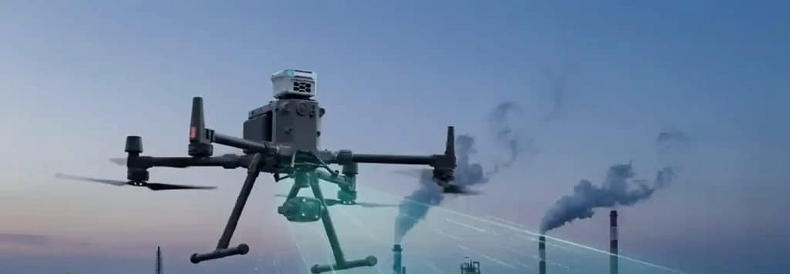 Surveillance drone flying over an oil and gas processing facility at dusk